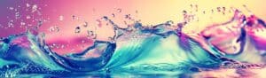 Abstract image of water splashes with a vibrant color scheme, featuring flowing waves in shades of blue, pink, purple, and yellow, creating a dynamic and energetic visual.