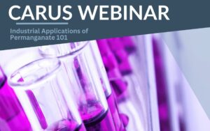 Text reading "CARUS WEBINAR: Industrial Applications of Permanganate 101" over a background image of test tubes filled with a purple liquid.